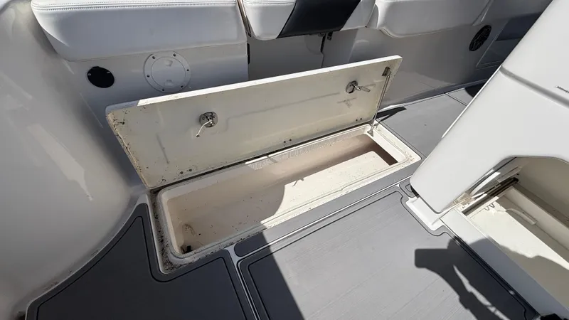 Slide: The Image of Open storage compartment on 2021 Robalo R302 Center Console boat deck. - 27