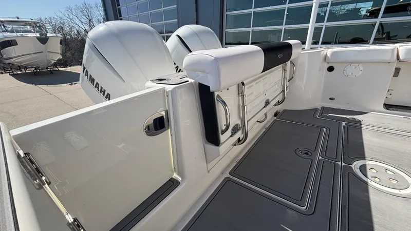 Slide: The Image of 2021 Robalo R302 Center Console boat with Yamaha engines, docked near a building. - 29