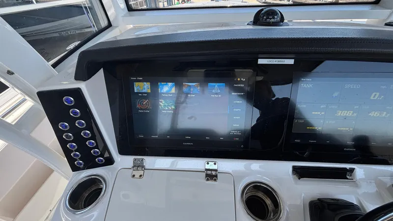 Slide: The Image of 2021 Robalo R302 Center Console dashboard with touchscreen controls and navigation display. - 36