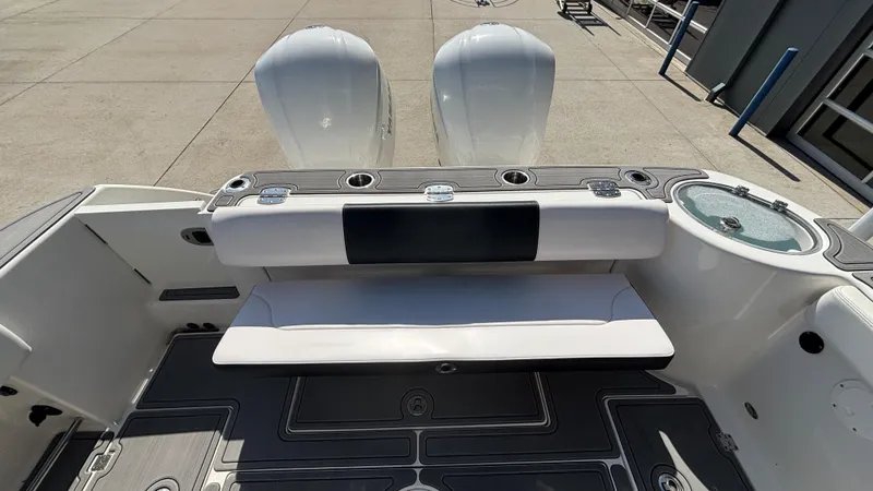 Slide: The Image of 2021 Robalo R302 Center Console boat with dual engines and seating area. - 5