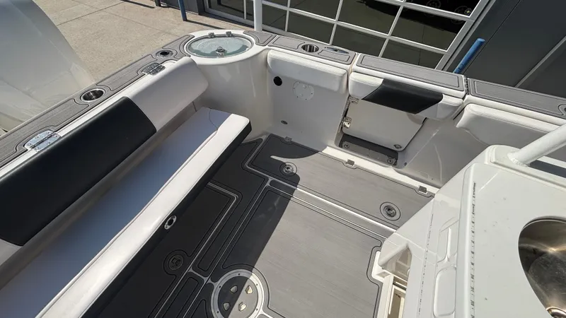 Slide: The Image of 2021 Robalo R302 Center Console boat interior with seating and storage compartments. - 6