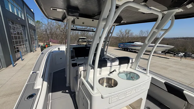 Slide: The Image of 2021 Robalo R302 Center Console boat with sleek design and modern features. - 9