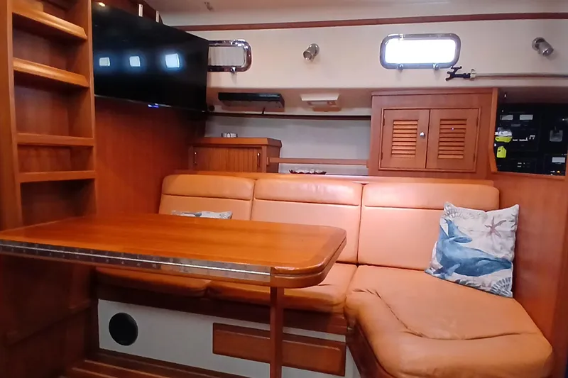 Slide: The Image of Interior of 2006 Island Packet 440 yacht with leather seating and wooden table. - 10
