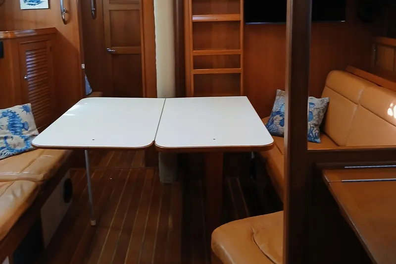 Slide: The Image of Interior of 2006 Island Packet 440 yacht with dining area and wooden finish. - 12