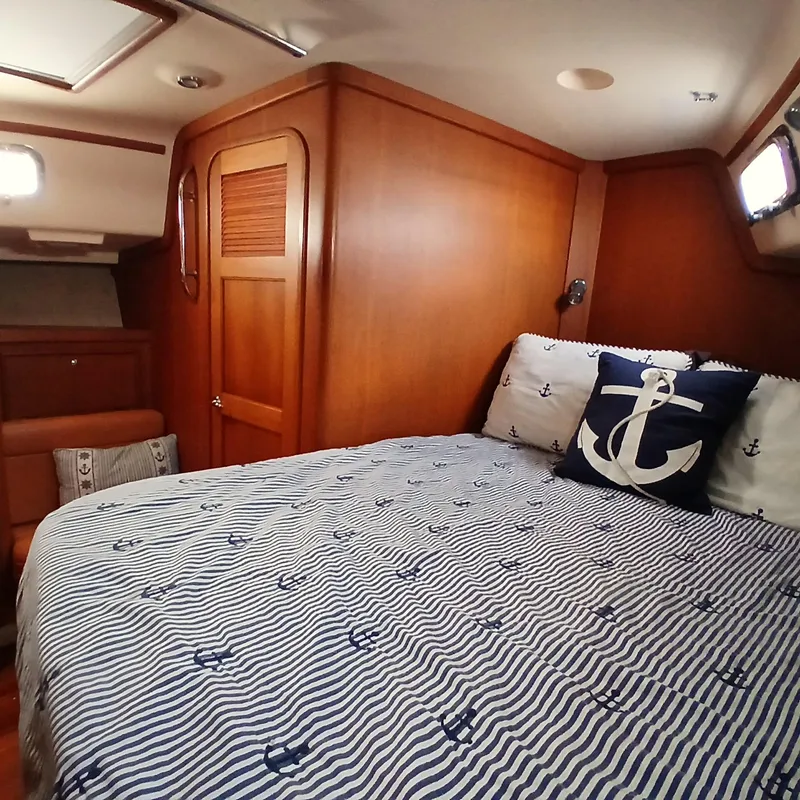 Slide: The Image of Cozy cabin interior of 2006 Island Packet 440 yacht with nautical-themed bedding. - 15