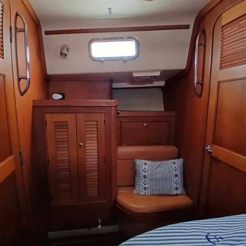 Slide: The Image of Interior of 2006 Island Packet 440 sailboat with wooden cabinetry and seating. - 18