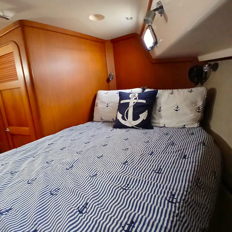 Slide: The Image of Cozy cabin interior of 2006 Island Packet 440 with nautical-themed bedding. - 19