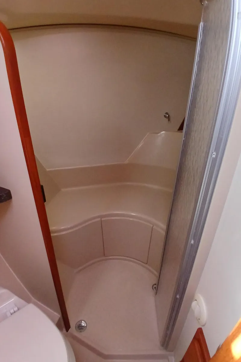 Slide: The Image of 2006 Island Packet 440 yacht bathroom with curved shower and beige interior. - 22