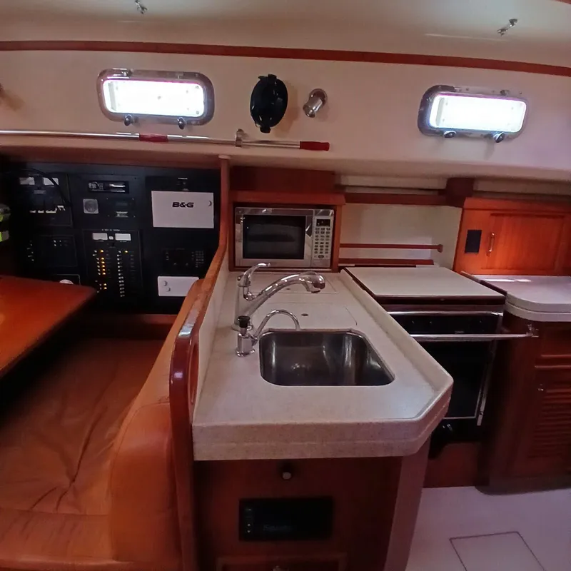 Slide: The Image of Interior of 2006 Island Packet 440 yacht showing kitchen area with sink and appliances. - 25