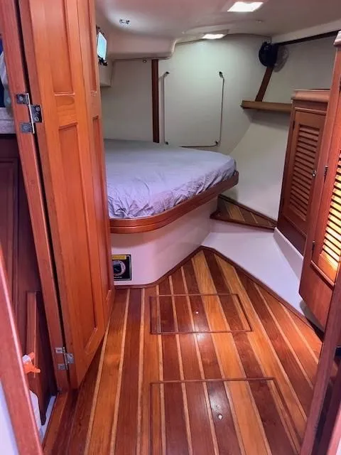 Slide: The Image of 2006 Island Packet 440 yacht interior with wooden flooring and cozy sleeping area. - 34