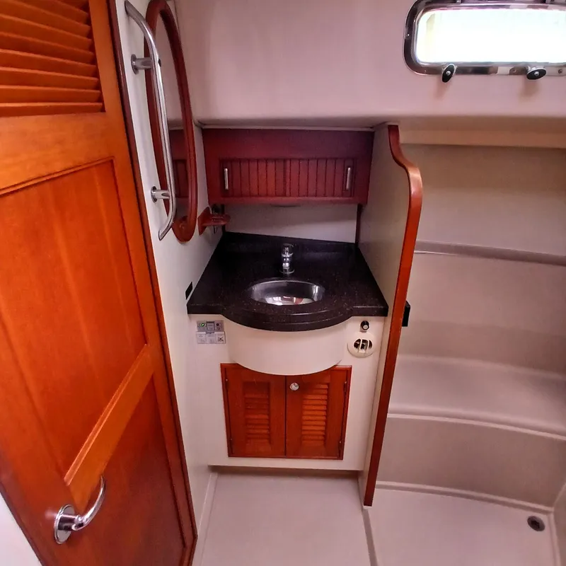 Slide: The Image of 2006 Island Packet 440 yacht bathroom with wooden cabinetry and compact sink. - 35