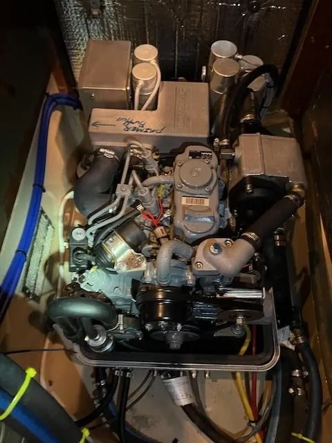 Slide: The Image of Engine compartment of a 2006 Island Packet 440 sailboat, showcasing detailed mechanical components. - 38