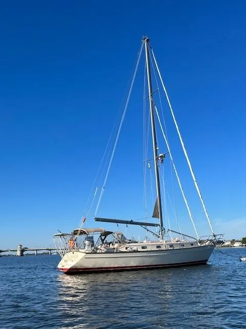 Slide: The Image of 2006 Island Packet 440 sailboat on calm water under clear blue sky. - 4