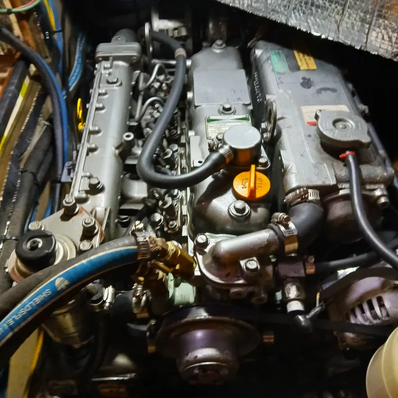 Slide: The Image of Engine compartment of a 2006 Island Packet 440 sailboat, showcasing detailed mechanical components. - 40