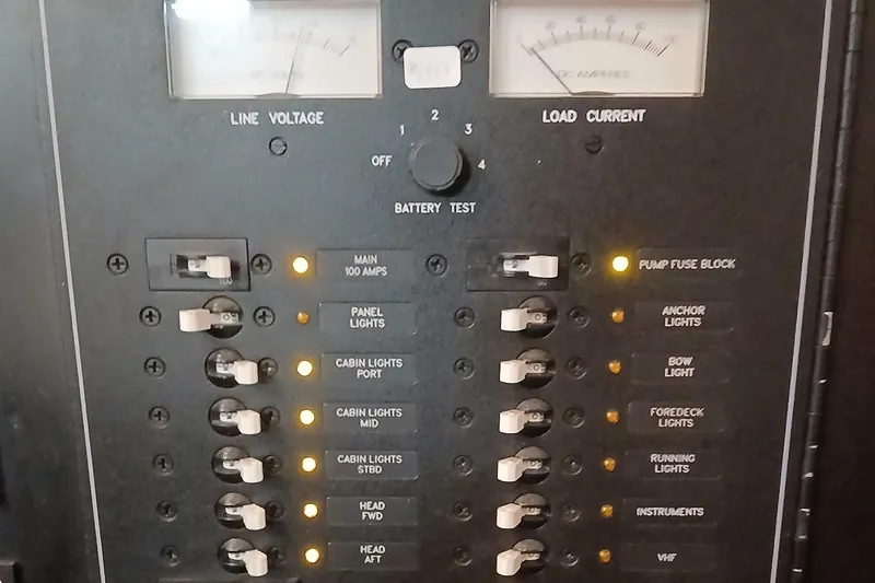 Slide: The Image of Electrical panel of a 2006 Island Packet 440 sailboat with switches and meters. - 42