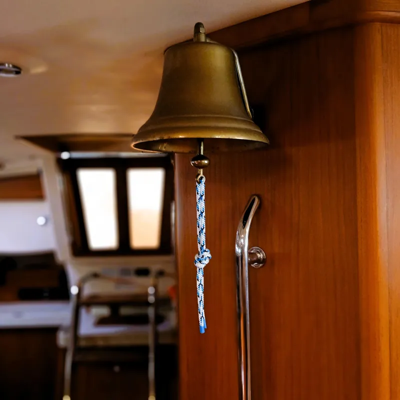 Slide: The Image of Brass bell inside 2006 Island Packet 440 yacht, with blue rope pull. - 46