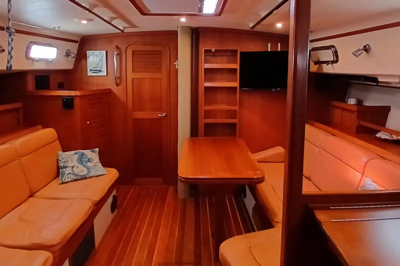 Slide: The Image of Interior of 2006 Island Packet 440 yacht with wooden furnishings and cozy seating. - 9