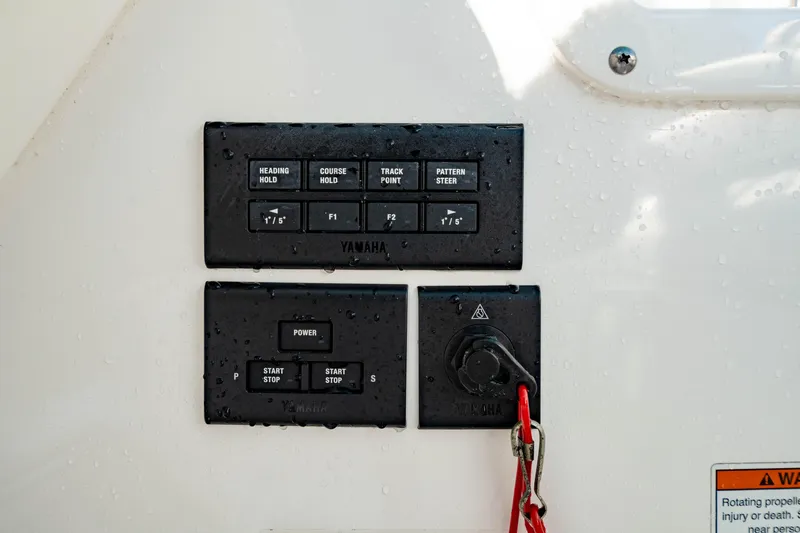 Slide: The Image of Control panel of 2022 Edgewater 262 CX boat with Yamaha buttons and safety key. - 10