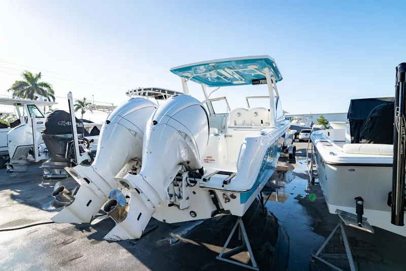 Slide: The Image of 2022 Edgewater 262 CX boat with dual outboard engines, displayed outdoors. - 11