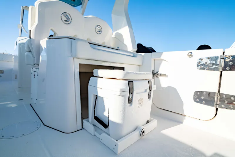 Slide: The Image of 2022 Edgewater 262 CX boat interior with cooler storage and seating. - 15