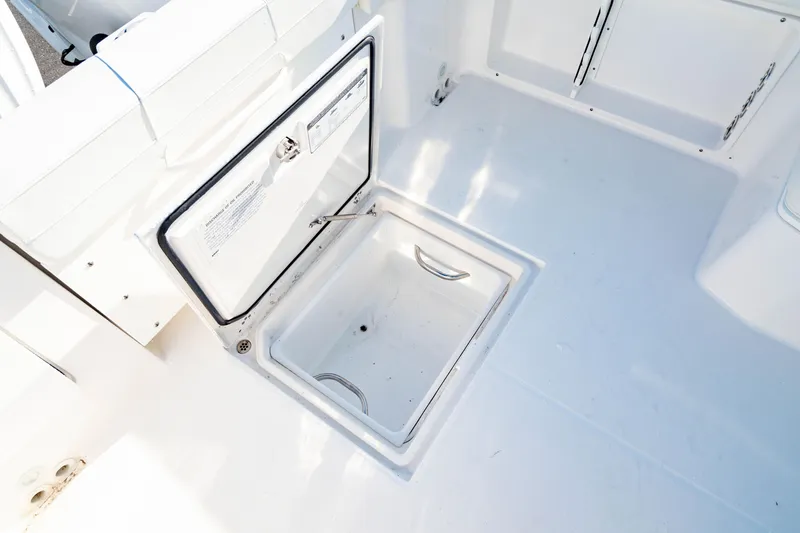Slide: The Image of Open storage compartment on 2022 Edgewater 262 CX boat deck. - 16