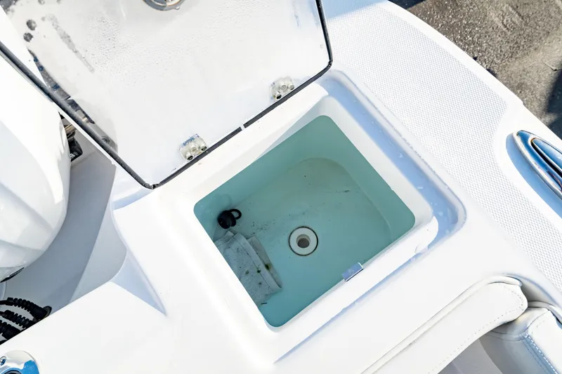 Slide: The Image of Open storage compartment on 2022 Edgewater 262 CX boat. - 17
