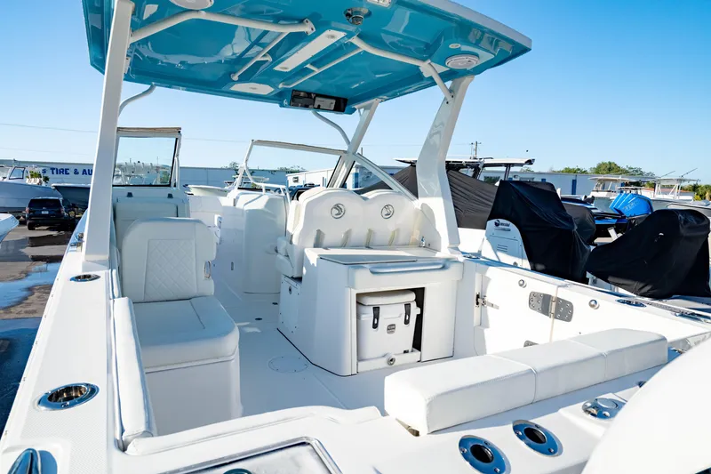 Slide: The Image of 2022 Edgewater 262 CX boat interior with seating and storage, showcasing modern design and functionality. - 2