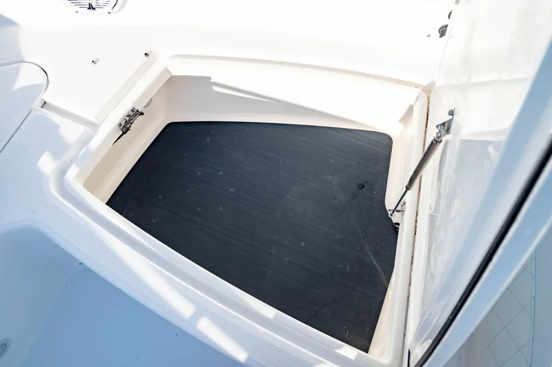 Slide: The Image of Storage compartment of 2022 Edgewater 262 CX boat, featuring a spacious interior. - 21