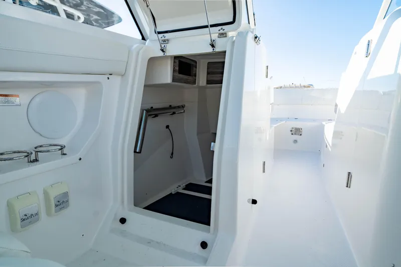 Slide: The Image of 2022 Edgewater 262 CX boat interior with open cabin and storage compartments. - 26