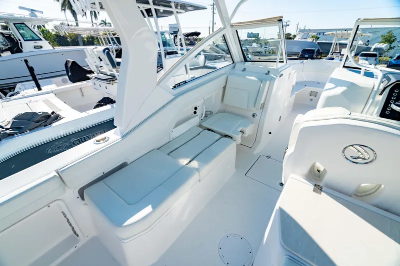 Slide: The Image of 2022 Edgewater 262 CX boat interior with white seating and modern design. - 29