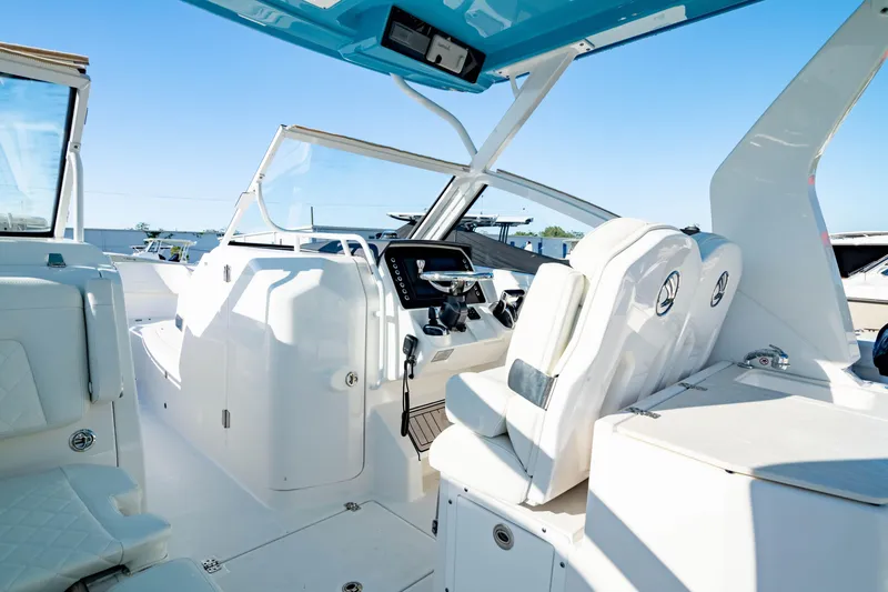Slide: The Image of 2022 Edgewater 262 CX boat interior with modern helm and seating. - 31