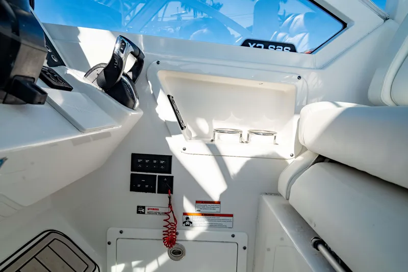 Slide: The Image of Interior view of 2022 Edgewater 262 CX boat cockpit with controls and seating. - 34