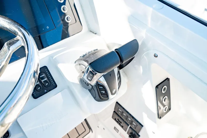 Slide: The Image of 2022 Edgewater 262 CX boat controls and steering wheel in cockpit. - 37