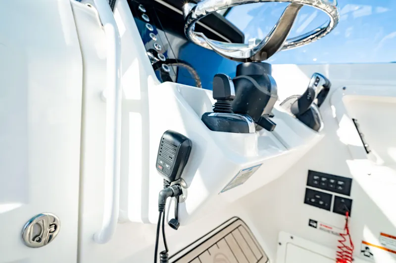 Slide: The Image of Edgewater 262 CX 2022 boat dashboard with steering wheel and controls. - 38