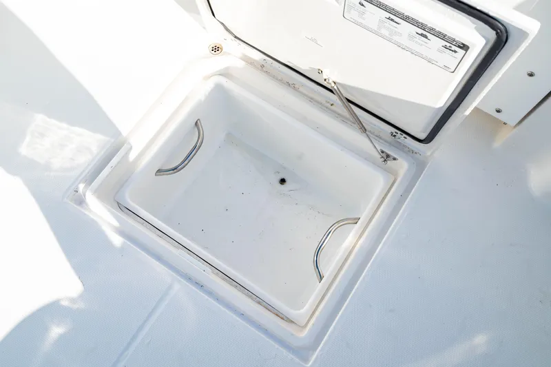 Slide: The Image of 2022 Edgewater 262 CX boat storage compartment with open lid, showcasing interior space. - 40