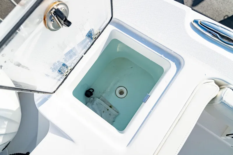 Slide: The Image of Livewell compartment on 2022 Edgewater 262 CX boat, open lid, white interior. - 42