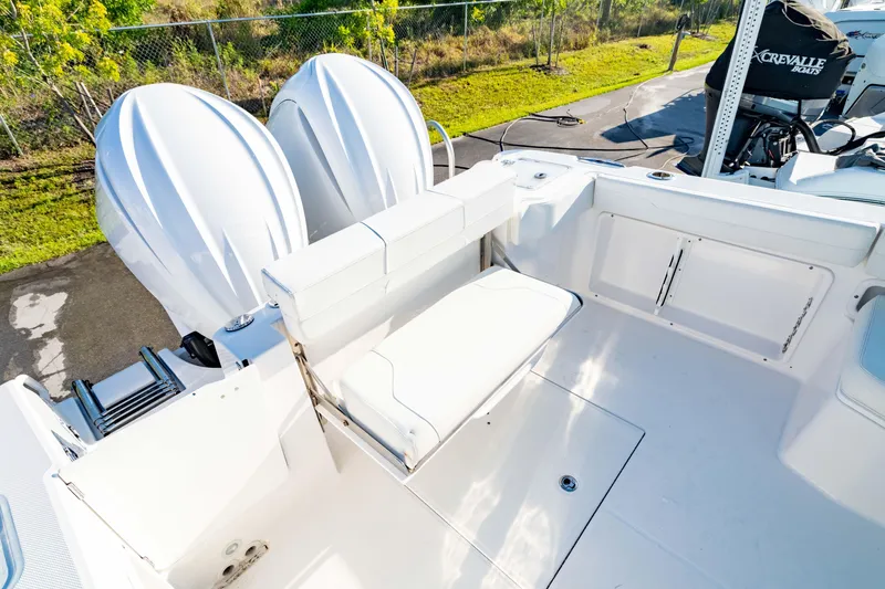 Slide: The Image of 2022 Edgewater 262 CX boat deck with seating and dual engines. - 8