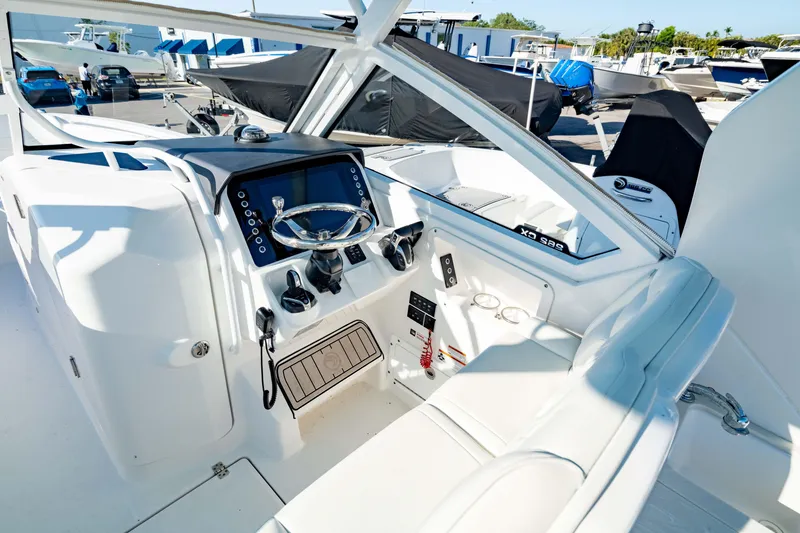 Slide: The Image of 2022 Edgewater 262 CX boat cockpit with modern controls and steering wheel. - 9