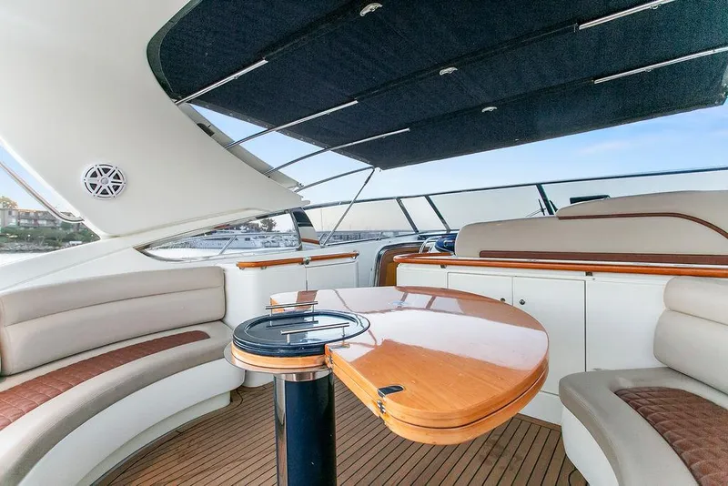 Slide: The Image of Luxurious 2004 Riva 59 Mercurius yacht interior with elegant seating and wooden table. - 10