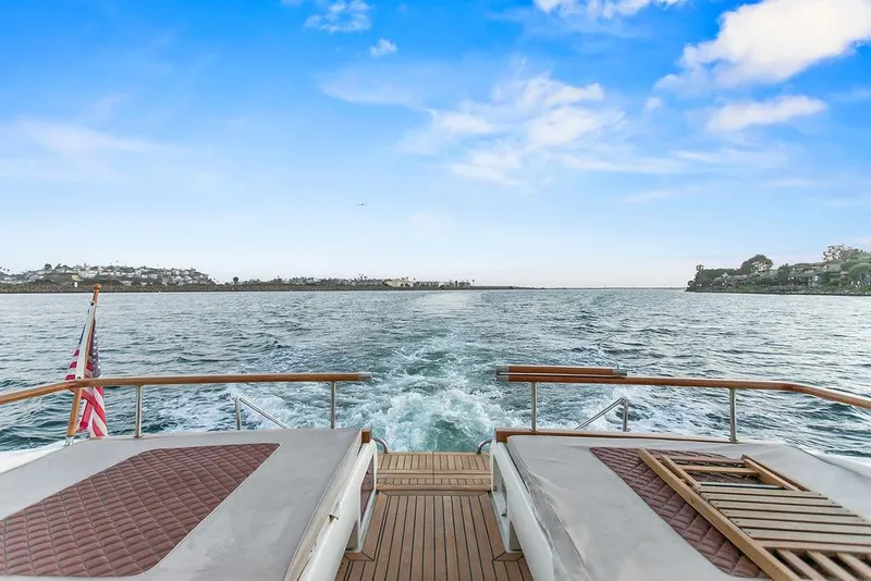 Slide: The Image of 2004 Riva 59 Mercurius yacht cruising on open water under a clear blue sky. - 11