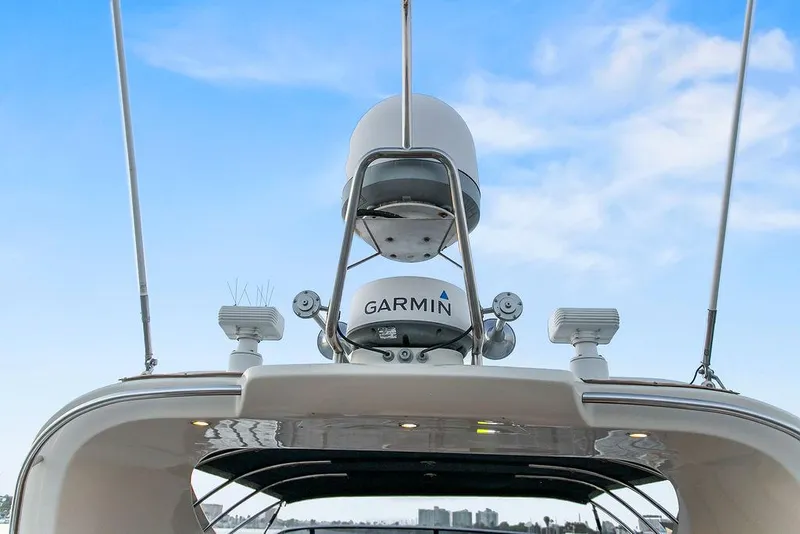 Slide: The Image of 2004 Riva 59 Mercurius yacht with Garmin radar against a clear blue sky. - 14