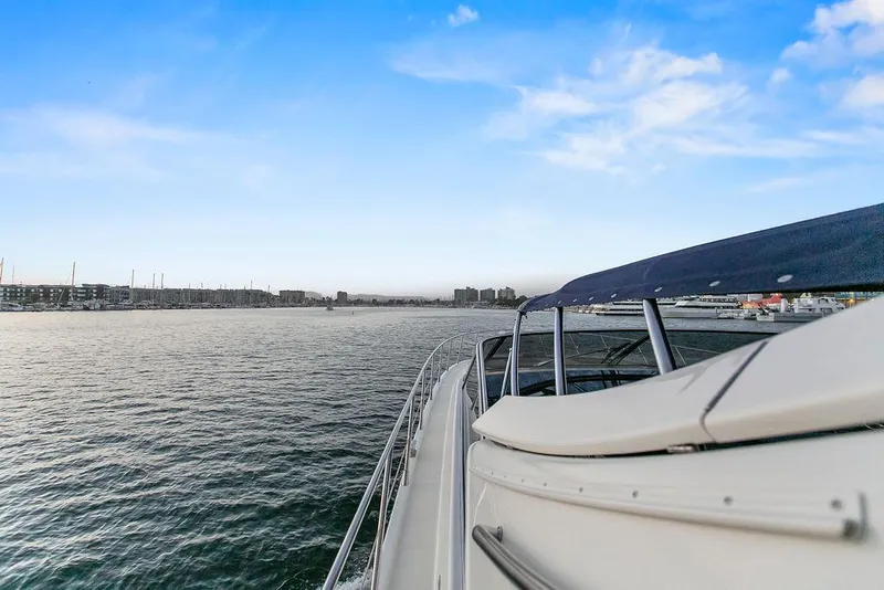 Slide: The Image of 2004 Riva 59 Mercurius yacht cruising on calm waters under a clear blue sky. - 15