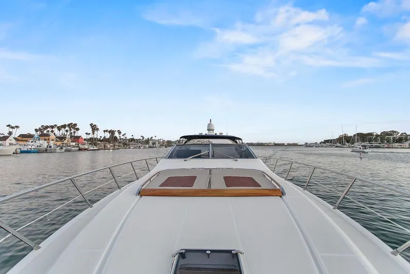 Slide: The Image of 2004 Riva 59 Mercurius yacht cruising in a scenic harbor with blue skies. - 17