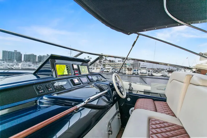 Slide: The Image of Luxurious 2004 Riva 59 Mercurius yacht cockpit with modern navigation equipment and plush seating. - 19