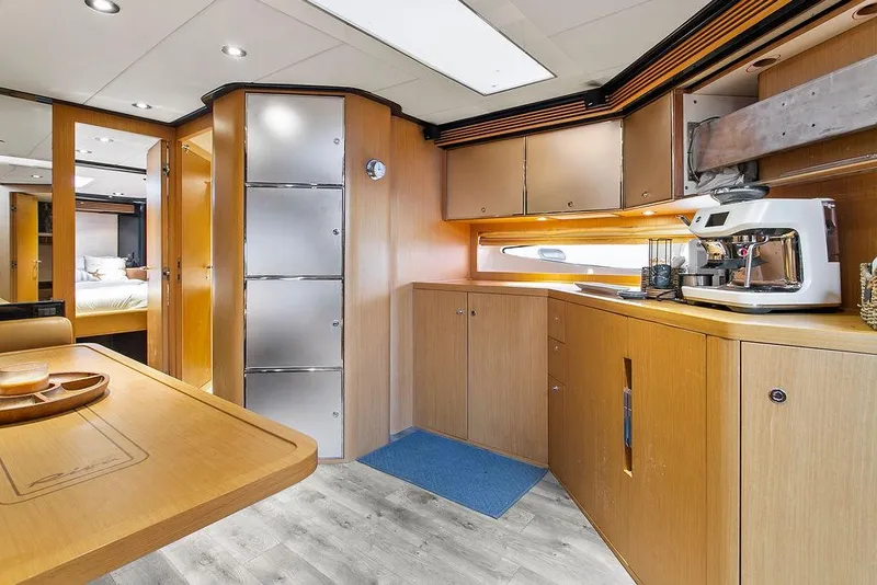 Slide: The Image of Luxurious interior of a 2004 Riva 59 Mercurius yacht with modern kitchen amenities. - 22