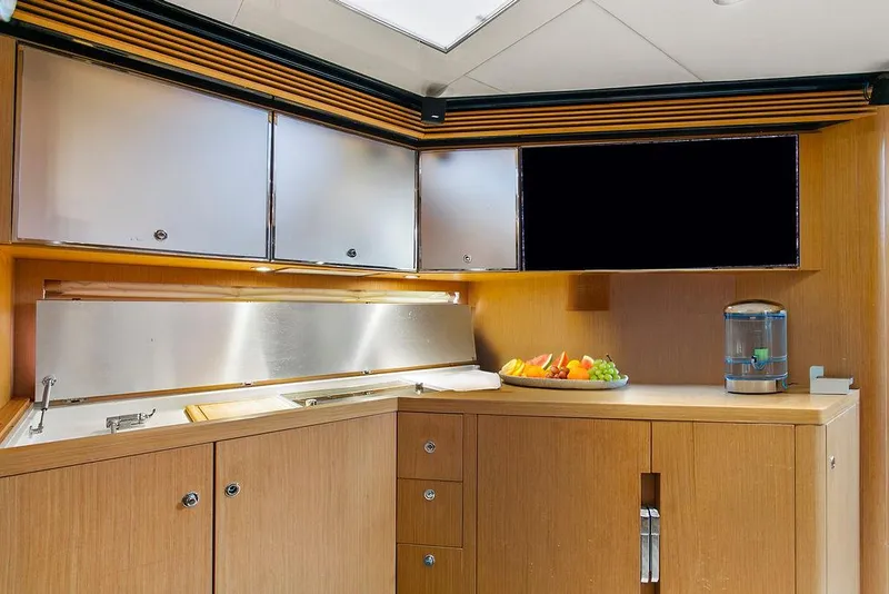Slide: The Image of Luxurious kitchen interior of 2004 Riva 59 Mercurius yacht with modern cabinetry and fruit display. - 24