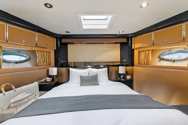 Slide: The Image of Luxurious cabin interior of 2004 Riva 59 Mercurius yacht with elegant bedding and porthole windows. - 26