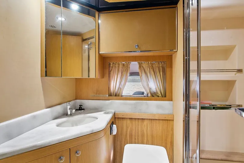 Slide: The Image of Luxurious bathroom interior of 2004 Riva 59 Mercurius yacht with modern fixtures and wood accents. - 30