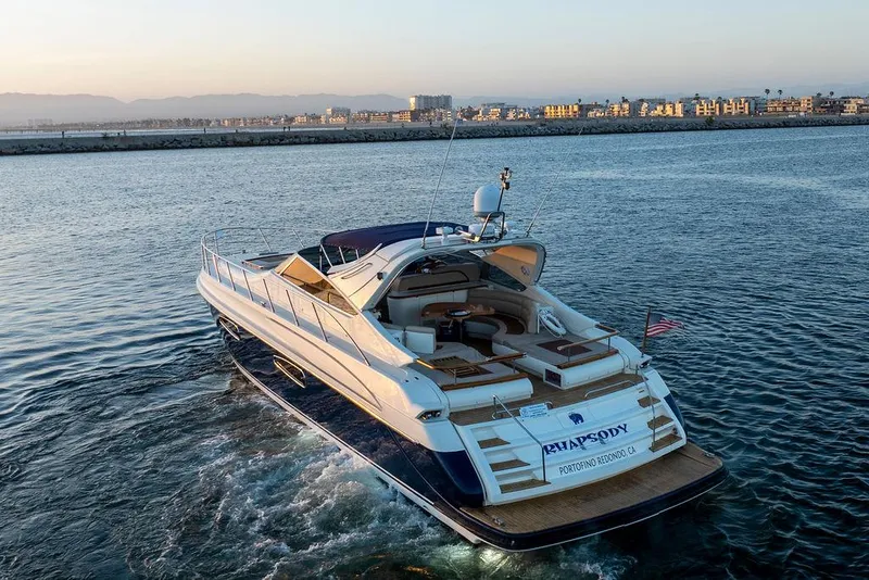 Slide: The Image of Luxurious 2004 Riva 59 Mercurius yacht cruising on serene waters at sunset. - 32