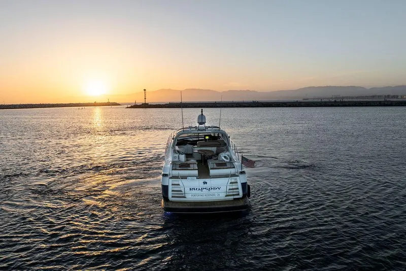 Slide: The Image of 2004 Riva 59 Mercurius yacht cruising at sunset on open water. - 33